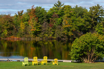 Muskoka chairs by the water fall colours 
