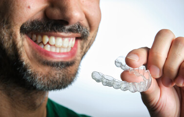 man with transparent dental retainer