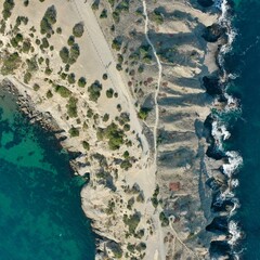 Panorama of cape Kaptchick, South Crimea. aerial photography. Blue sea and yellow rocks with green bushes. Camera straight down - obrazy, fototapety, plakaty