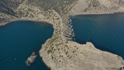 Panorama of cape Kaptchick, South Crimea. aerial photography. Blue sea and yellow rocks with green bushes. Camera straight down - obrazy, fototapety, plakaty