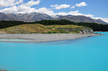 Fototapeta na wymiar View of milky blue of Lake Pukaki with beautiful view on Southern Alps in the background in South Island New Zealand