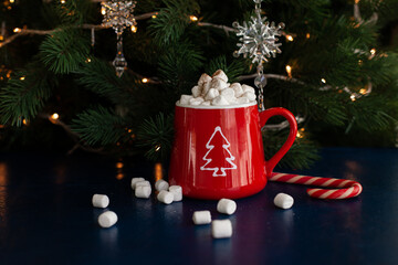 christmas hot chocolate cocoa with marshmallows and candy cane in a red mug