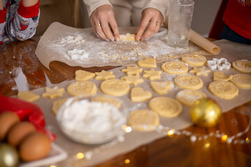 Merry Christmas and Happy Holiday. Christmas cookies close-up process cooking. Mom cooks with the children.