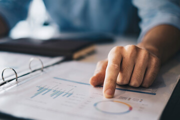 Businessman accountant or banker pointing at pie chart and audit finance planning sales to meet targets. finance concept.