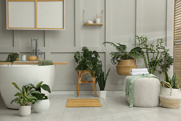Stylish bathroom interior with green plants. Home design