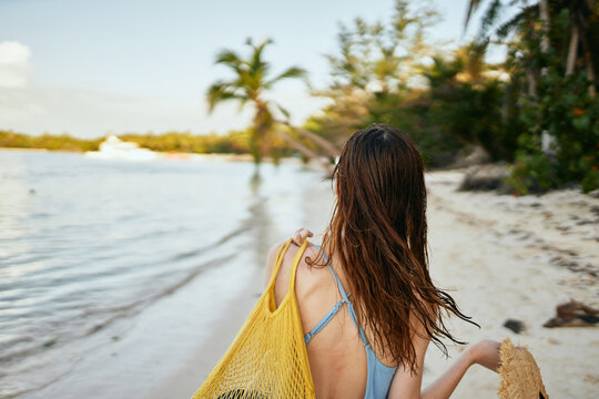 woman wearing sunglasses blue swimsuit island beach sun
