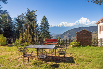 Hotel lawn with tourist sitting area and view of scenic Himalaya mountain landscape at Narkanda, Himachal Pradesh, India