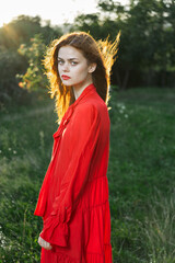 attractive woman in red dress outdoors in freedom field