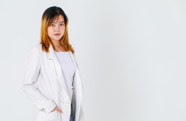 Portrait studio shot of Asian trendy fashionable urban beautiful happy dyed hair female model in casual long suit t shirt and denim jeans standing smiling look at camera posing on white background