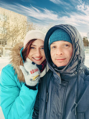 family selfie portrait of young couple in winter outdoors