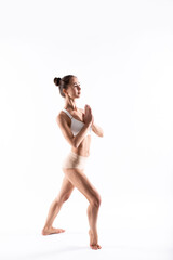 Sporty woman with a good figure posing on a white background.