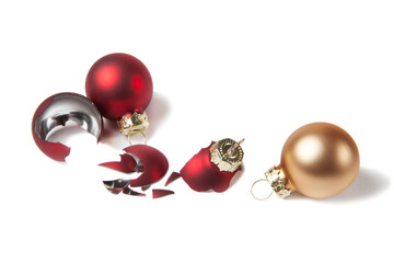 Broken red christmas ball and safe golden christmas ball on isolated white background