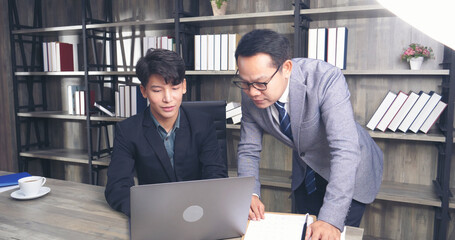 Businessman mentor coworker at office desk as team leader bossy manager. Two business people talking together start up new project planning strategy office meeting room. Businessman discuss, planning