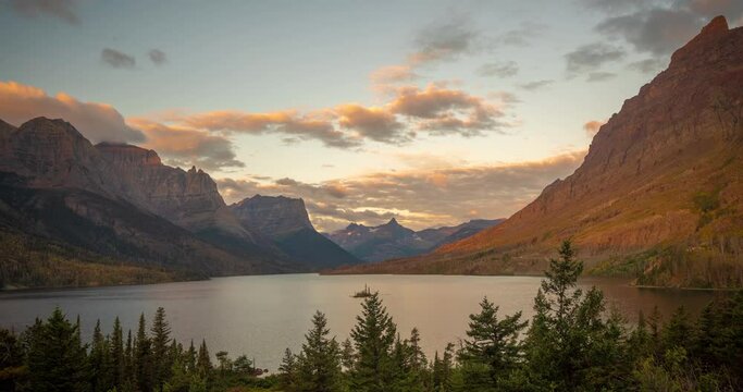 Cinematic Time Lapse of Heavenly Nature, Golden Clouds Above Mountain Peaks and Valley. St. Mary Lake, Glacier National Park, Montana USA