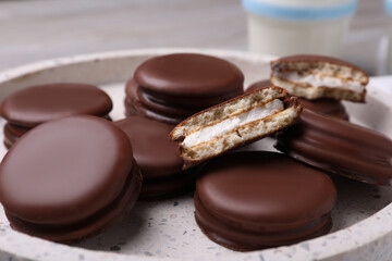 Tasty choco pies in plate, closeup view