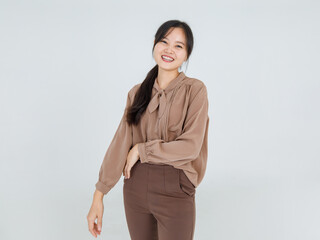 Lovely Asian girl cheerfully laugh and smile on happy face with attractive charming brown blouse as casual outfit for female lifestyle