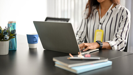 Female in a business strategy team working on her laptop computer