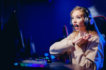 woman streamer play on online video game tournament, neon color