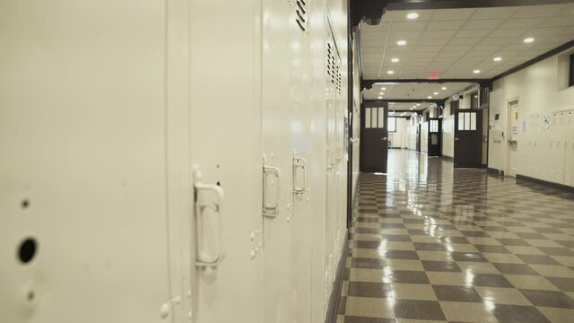 Brown lockers at a High school wait out the summer for new students