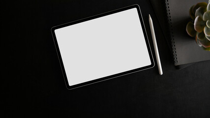 Top view of tablet with white screen display on black background.