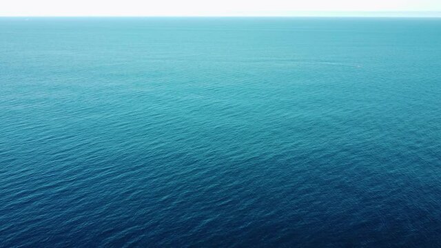 Aerial view of the open blue sea. Nothing but blue water ocean.