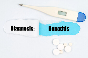 Medical diagnosis. On paper a thermometer, pills and a hole, inside which the inscription -...