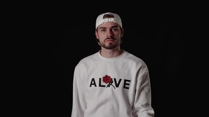 Trendy 20s Man giving thumb up, appreciative gesture, wide, black background