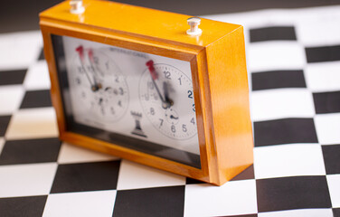classic, mechanical chess clock on wooden chess board