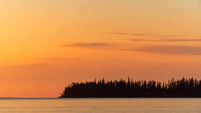 Sunset timelapse over beautiful Kuto Bay, Island of Pines. Soft orange color to red then black.