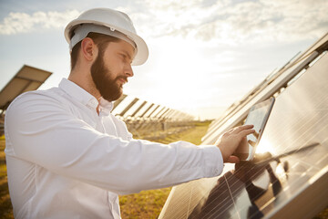Male engineer configuring solar panel