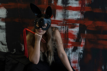 young beautiful woman in a leather hare mask and with a whip, bdsm, fetish