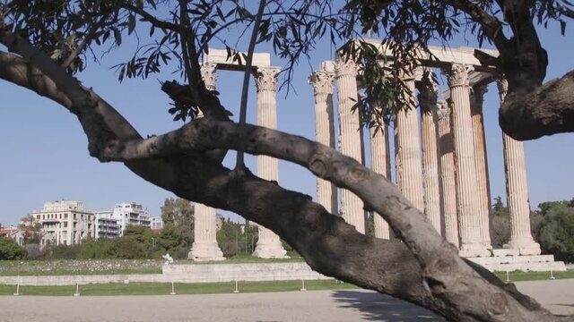 Ancient greek ruins of ionic columns among nature in the center of Athens, Greece.