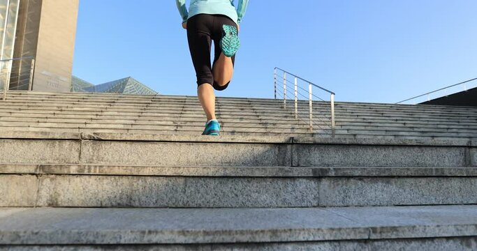 Fitness sports woman running up stairs in city