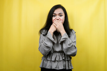 Beautiful young woman surprised, shocked, wow expression, hand covering mouth, presenting something, promoting product, advertisement, isolated