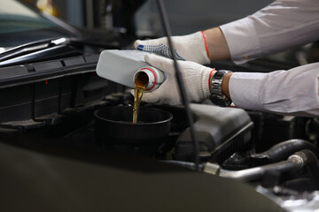 Refueling and pouring oil quality into engine motor car