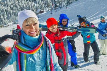 Portrait of group of skiers standing on ski slope 