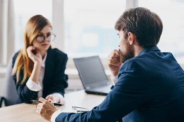 Fototapeta premium managers in the office in front of a laptop career network professionals