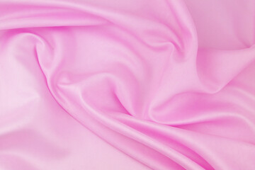 Pink satin fabric background. Wedding backdrop or holidays design element.	