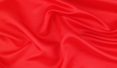 Red satin or silk fabric backdrop. Beautiful wallpaper, wedding background or design element. 