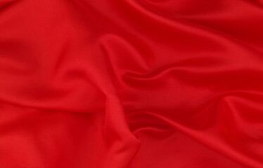 Red satin or silk fabric backdrop. Beautiful wallpaper, wedding background or design element.	
