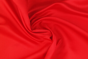 Red satin or silk fabric backdrop. Beautiful wallpaper, wedding background or design element.	