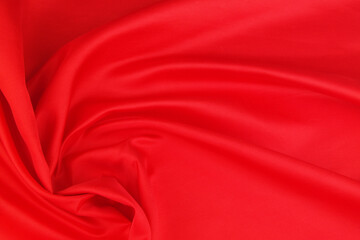 Obraz premium Red satin or silk fabric backdrop. Beautiful wallpaper, wedding background or design element. 