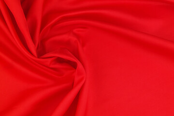 Obraz premium Red satin or silk fabric backdrop. Beautiful wallpaper, wedding background or design element. 