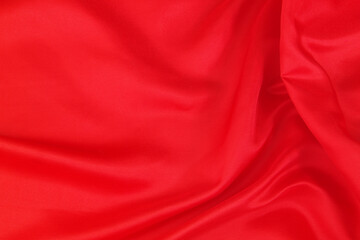 Red satin or silk fabric backdrop. Beautiful wallpaper, wedding background or design element.	