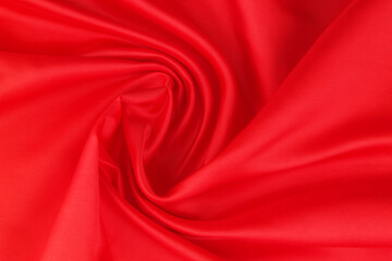 Red satin or silk fabric backdrop. Beautiful wallpaper, wedding background or design element.	