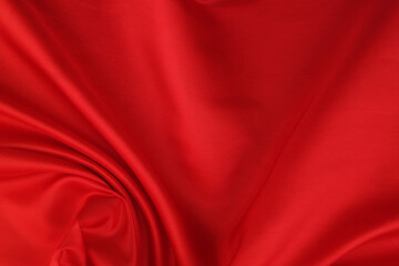 Red satin or silk fabric backdrop. Beautiful wallpaper, wedding background or design element.	