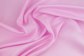 Obraz premium Pink satin or silk fabric background. 