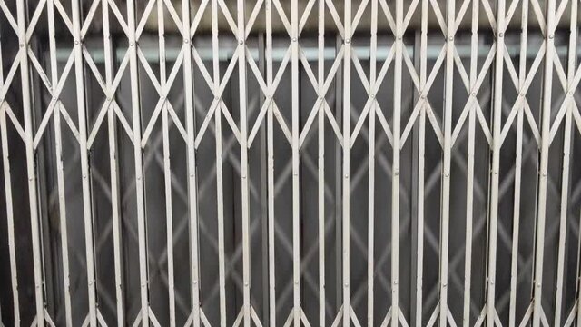 View Through Manual Steel Gate Of Vintage Elevator Ascending In Hong Kong. static