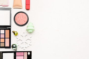 Fototapeta premium Set of makeup cosmetics with Christmas decor on white background