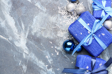 Beautiful Christmas gifts with decor on blue background
